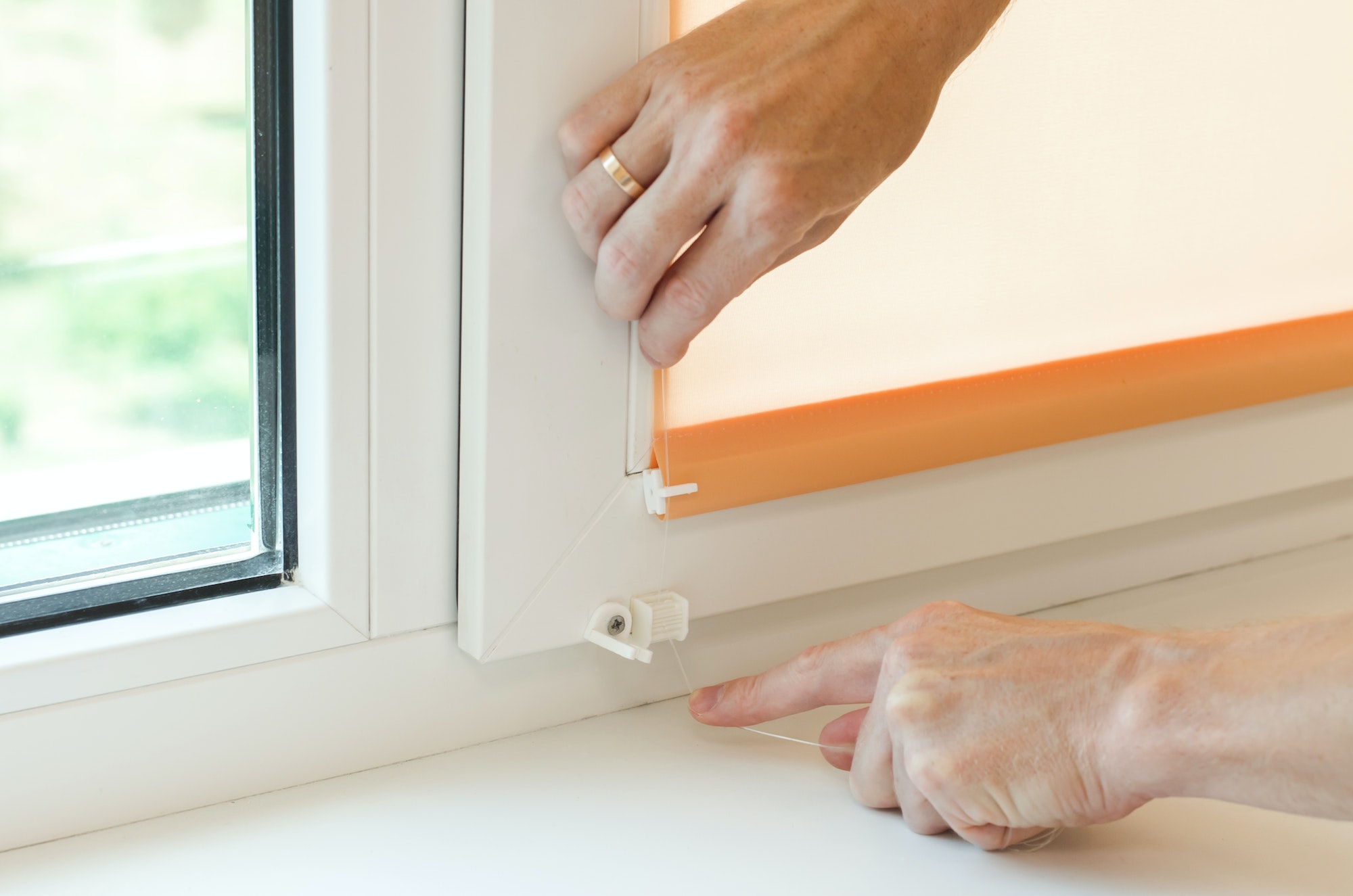 Assembly of roller blinds. Hands are assembling roller blinds, close-up
