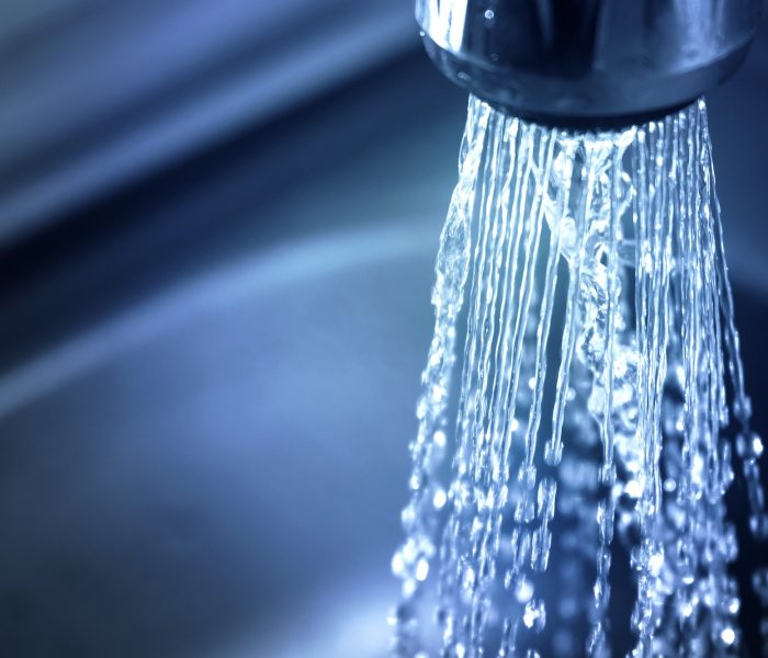 Concept water saving at home, reducing use. Water supply problems. Water tap with flowing water with Concept water saving at home, reducing use. Water supply problems. Water tap with flowing water with