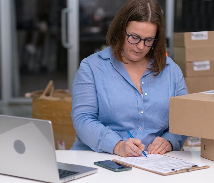 online store woman using laptop packing order express delivery. logistic solutions online shopping